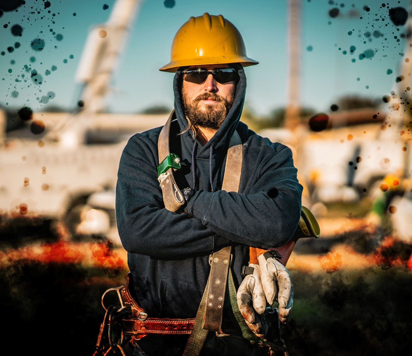 Image of lineworker posed with sunglasses and arms crosed
