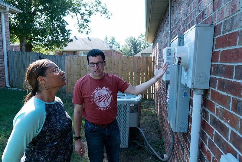 First Electric Solar services installer explaining to customer